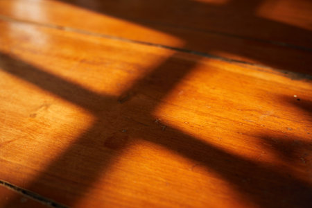 Close up Light and Shadow from window on wood groundの写真素材