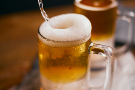Close up mug of beer on wooden tableの写真素材