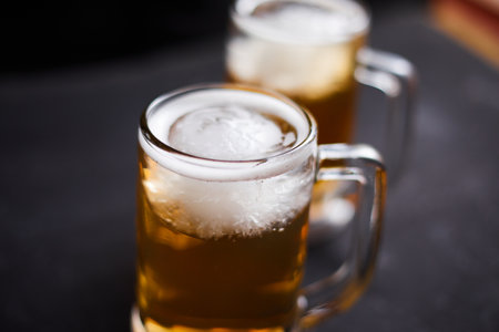 Close up mug of beer on wooden tableの写真素材