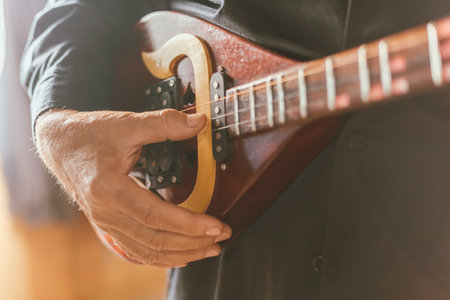 Close up hand playing Thai Mandolin, Phin in home studio.の写真素材