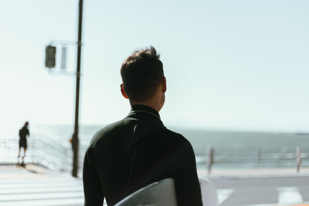 Black view of man walk with surfing board wait for wave to surf spot at sea.