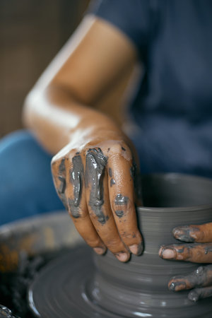 Hands of craftsman artist working on pottery wheel.Selective Focus