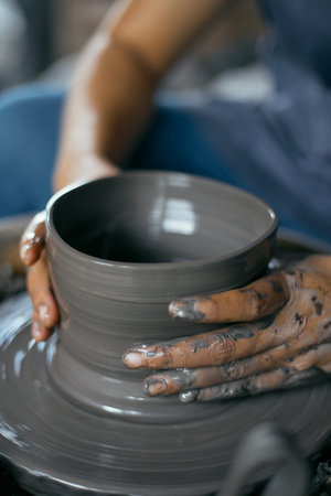 Hands of craftsman artist working on pottery wheel.Selective Focus