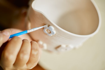 Close up hand of woman painting her pottery ceramic at studio.Â の写真素材