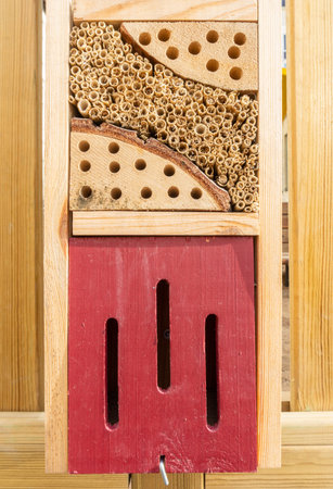 Stockholm, Sweden - Two compartment of insect hotel in urban environment with narrow openings and natural materialの写真素材