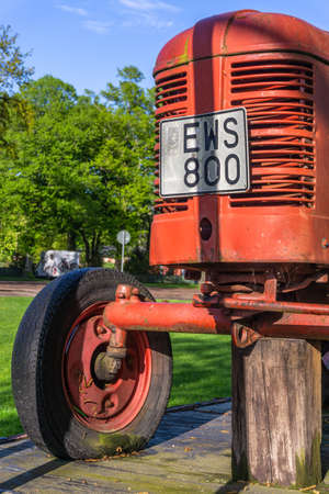 Vadstena, Sweden - May 23, 2021: Front part of an old tractor standing on loading platform with a front mask and register numberのeditorial素材