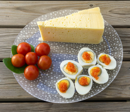 Stockholm, Sweden - April 7, 2021: A glass plate with typical swedish food with cheese, eggs and...