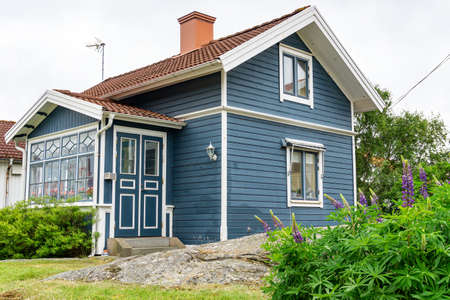 SmÃ¶gen, Sweden -June 10, 2021: Blue wooden swedish house on West coast of Sweden on islandのeditorial素材