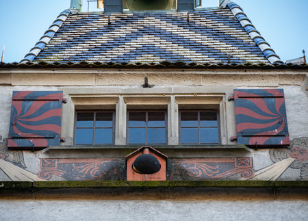 Zug, Switzerland - December 31, 2021: Close up view on the medieval tower with old windows and colorful roof tiles on the topのeditorial素材