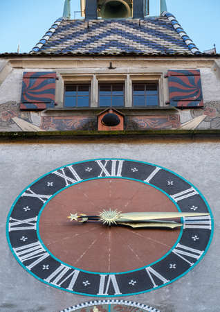 Zug, Switzerland - December 31, 2021: A tower in canton Zug with medieval clock and windows aboveのeditorial素材