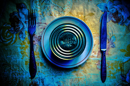  Conceptual serving of breakfast from canned food, knife and forks. Dramatic atmosphereの写真素材