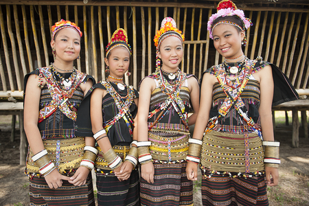 Kudat, Sabah Malaysia. April 10, 2013: Ladies from Rungus ethnic wearing traditional costume poses for the camera during the local Festival celeberation in Kudat, Sabah. Rungus tribe popular with colorful costume with a lot of beads.のeditorial素材