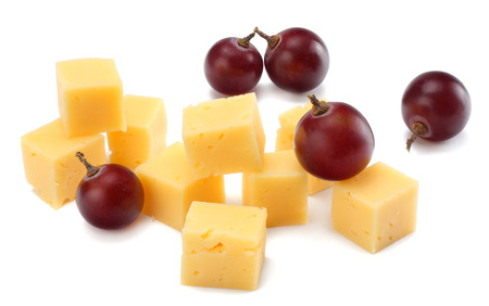 piece of cheese with grapes isolated on white backgroundの写真素材