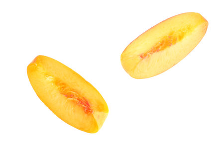 peach fruit slices isolated on white backgroundの写真素材