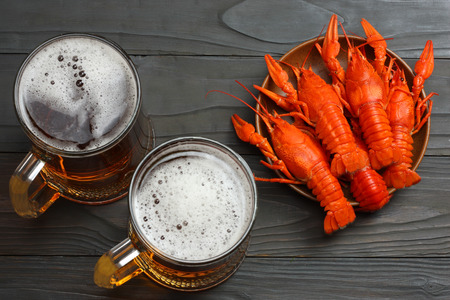 Glass beer with crawfish on dark wooden background. Beer brewery concept. Beer background. top viewの写真素材
