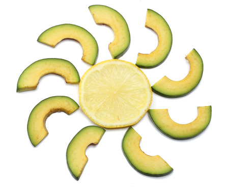 healthy food. sliced avocado with lemon isolated on white background. top viewの写真素材