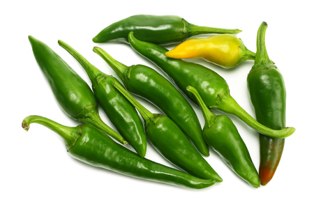 green hot chili peppers isolated on white background top viewの写真素材
