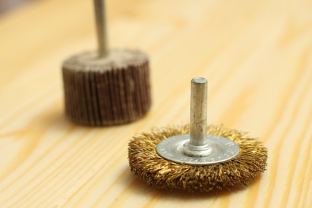 light wood background with round metal wire brush tool  for mechanical cleaning of metal and wood and remove rustの写真素材