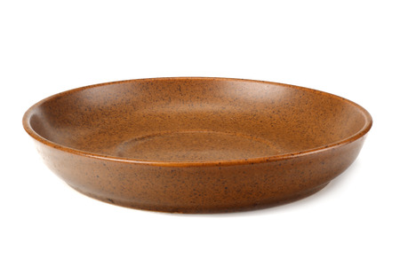 empty brown round plate isolated on a white backgroundの写真素材