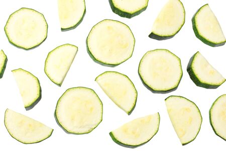 fresh green zucchini slices isolated on white background. top viewの写真素材