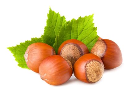 hazelnuts with green leaf isolated on white backgroundの写真素材