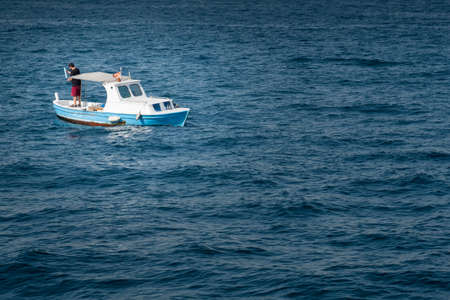 small fishing boat in the sea and fisher,の写真素材