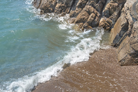 sands and waves on rocky beach, seaside