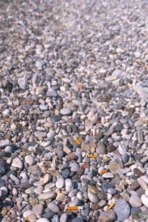 cigarette butts on the beachの写真素材