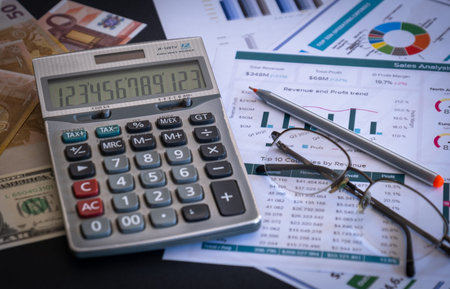 Business financial concept. Financial data, statistical charts and banknotes on the table.