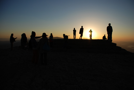Silhouette of a group of people at sunset.の写真素材