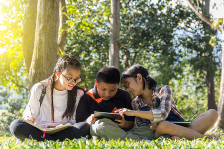 Child fun to play tablet in the parkの写真素材