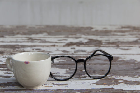 white cup and glasses on wooden