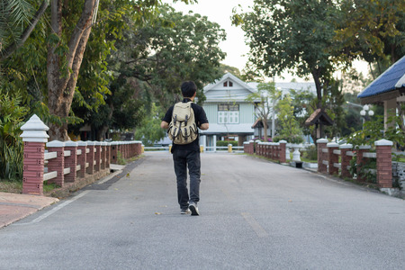Man with bag walking on street.travel conceptの写真素材