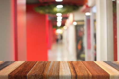 shop blurred background on wood table.の写真素材