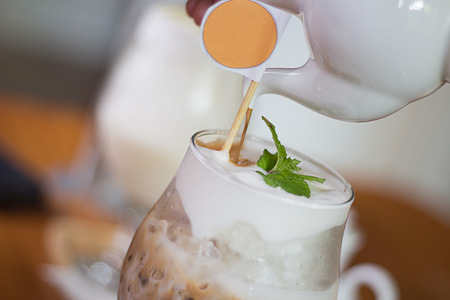 Fresh iced coffee and pot with circle logoの写真素材