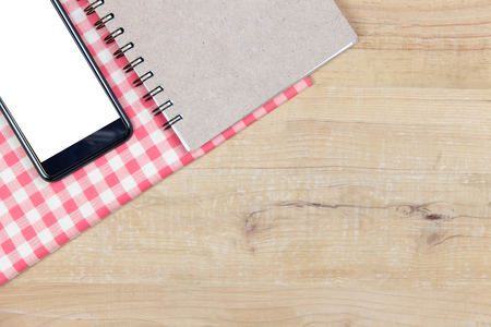 Cell phone with blank white screen on book. top viewの写真素材