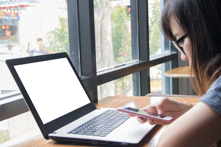 Girl with eyeglasses use smart phoneの写真素材