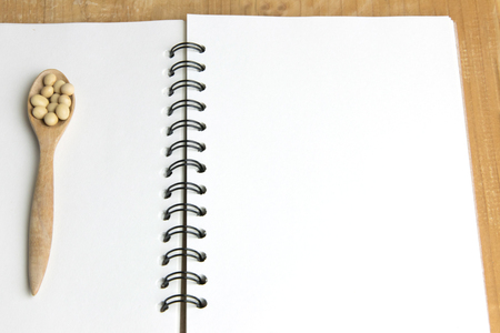 Soy bean on wood spoon with blank book of copy spaceの写真素材