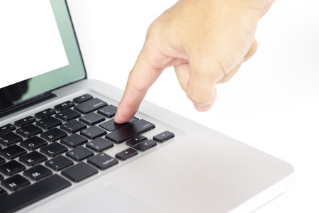 Hand press enter button on computer. white isolated background