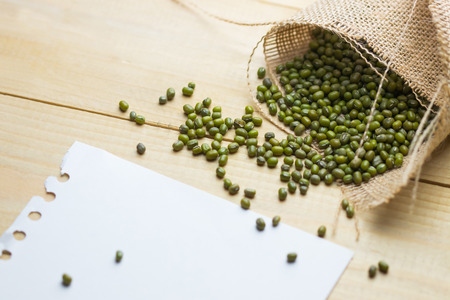 Mung Dried Bean and white paper on wooden table. copy spaceの写真素材