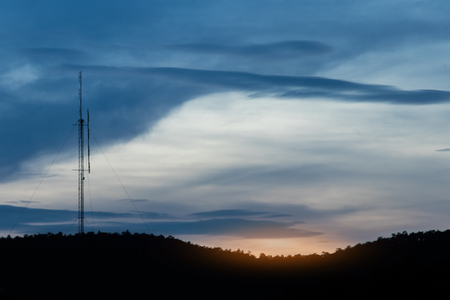 Radio pole sunset on mountain backgroundの写真素材