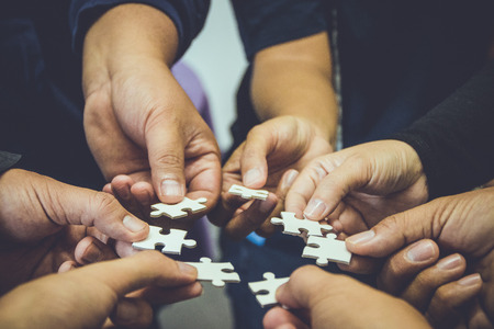 Teamwork group of hand holding jigsaw. business concept idea,の写真素材