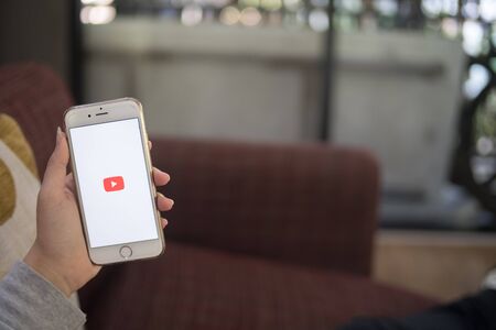Chiang Mai, Thailand - February 8 2018 : Young woman hold iphone 6 white color with youtube application logo on screen, copy space, for presentation productのeditorial素材