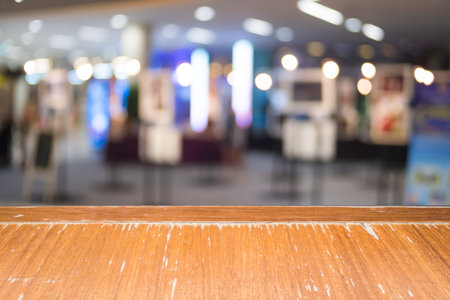 Wooden table of brown on front blurred background, blurred shopping mall, mock up, for presentation,...
