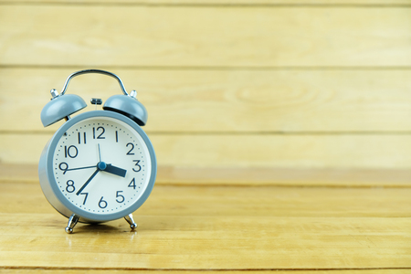 Close-up alarm clock on wooden table of brownの写真素材