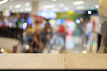 Wooden table of brown on front blurred shopping mall background, empty on wooden table for presentation productの写真素材