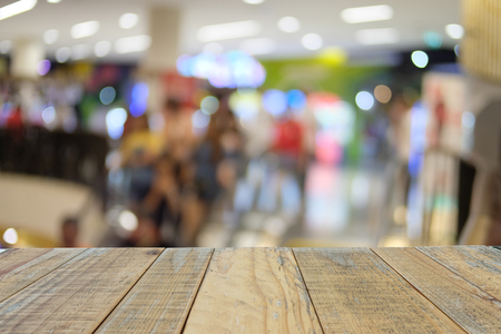 Empty wooden table on fron blurred shopping mall background, used for templated and presentation productの写真素材