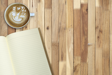 Hot coffee art and empty book on wooden table, copy space, for presentation and templateの写真素材