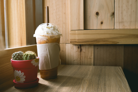 Iced cappuccino with topping cream on wooden table of brown, backgroundの写真素材