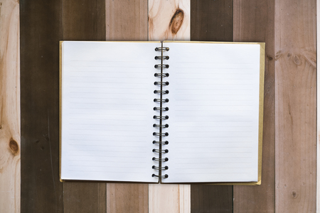 Empty book on wooden table of brown, top angle view, copy space for presentationの写真素材